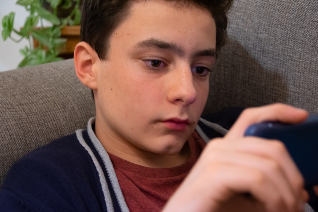 teenager scrolling phone